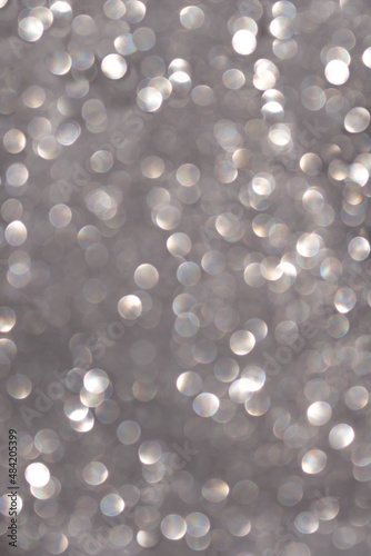 Grey-white silver defocused lights with glitter. Holiday, Christmas, New year, overlay. Copy space