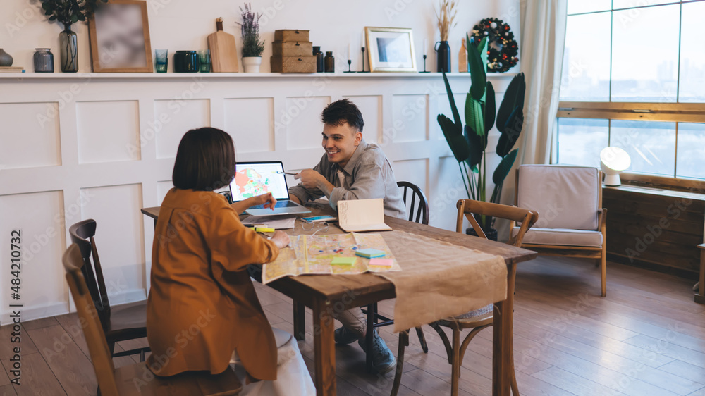 Couple planning vacation or journey at table Couple planning vacation or journey at table