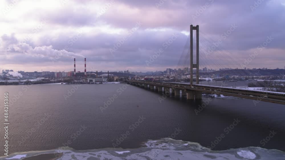 Garbage Incineration Plant Smokestack near the river. City traffic on the big bridge aerial view Garbage Incineration Plant Smokestack near the river. City traffic on the big bridge aerial view