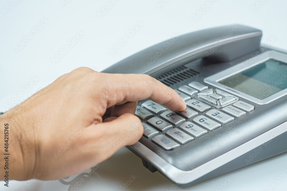 Male pointing hand trying to press number buttons on working employee concept. Male pointing hand trying to press number buttons on working employee concept.