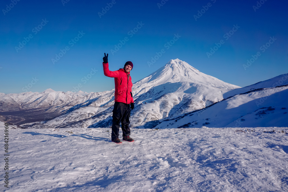 A man on the background of the Vilyuchinsky volcano