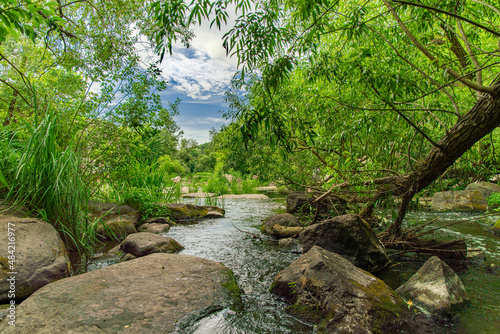 park outdoor landscape river stream with rocks and green foliage springtime environment