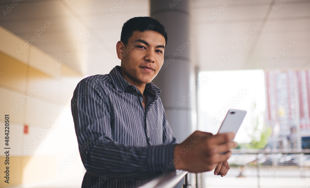 Young asian millennial guy use smartphone outdoor Young asian millennial guy use smartphone outdoor