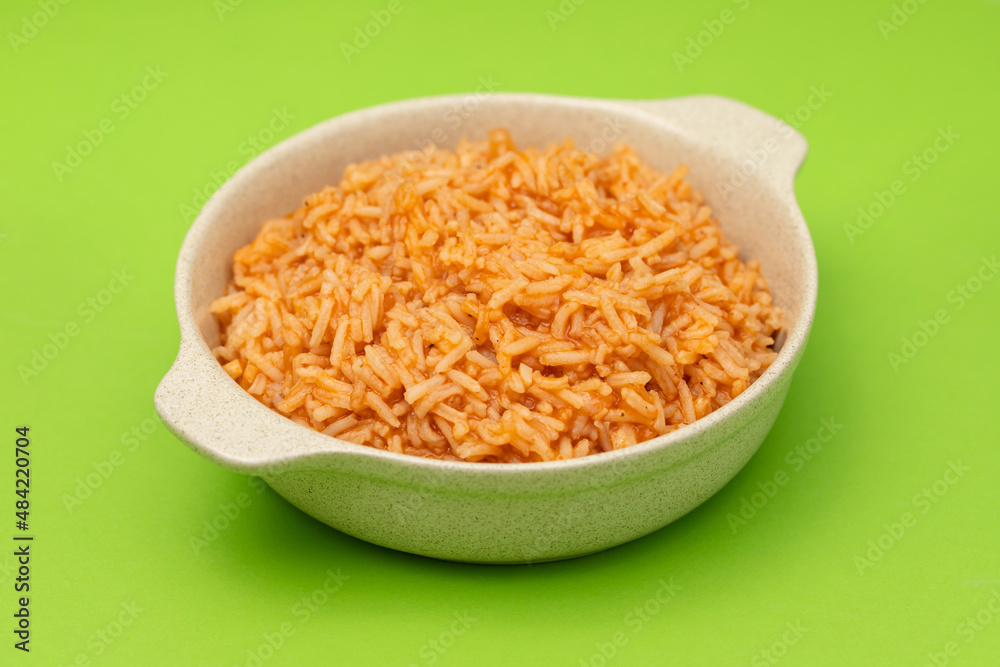 tomato rice on the dish on green background tomato rice on the dish on green background