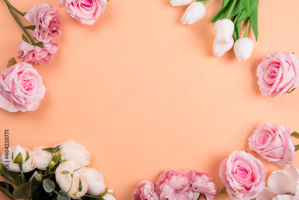 Colorful decorations t with spring flowers on orange background. copy space, top view