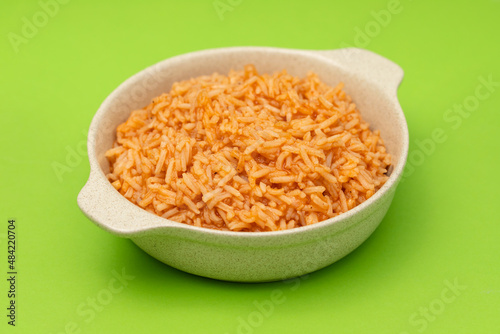 tomato rice on the dish on green background