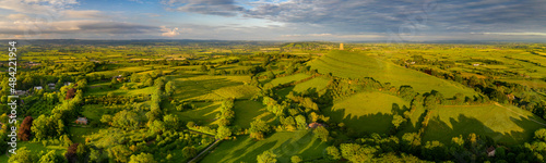 Aerial panorama of Glastonbury Tor and surrounding rolling countryside, Somerset, England