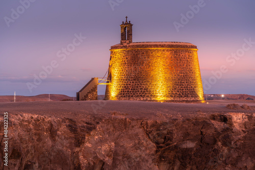 View of Castillo del Aguila o de las Coloradas at dusk, Playa Blanca, Lanzarote, Canary Islands photo