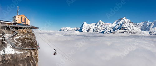 Aerial view of cable car in fog with Eiger, Monch, Jungfrau peaks in the background, Murren Birg, Jungfrau Region, Bern, Swiss Alps, Switzerland