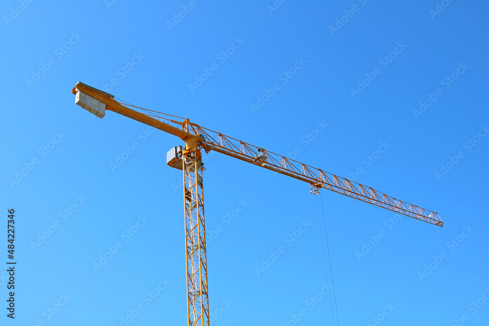 Construction crane on a new construction site of high-rise building