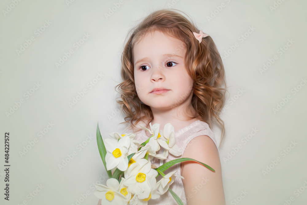 little charming girl holding daffodils white flowers for Easter on a beige background with a place for text little charming girl holding daffodils white flowers for Easter on a beige background with a place for text