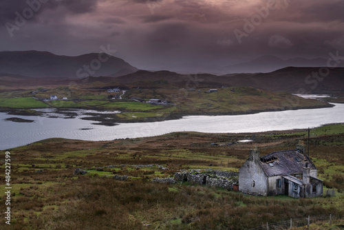 Abandoned Croft backed by Loch Eireasort and the Harris Hills, near Baile Ailein, Isle of Lewis, Outer Hebrides, Scotland photo