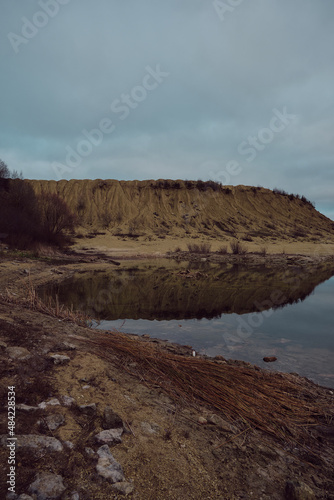 sand quarry with water in late autumn evening