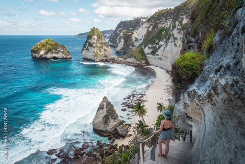 Bali, Indonesia, female traveler at idyllic Diamond Beach in Nusa Penida Island. photo