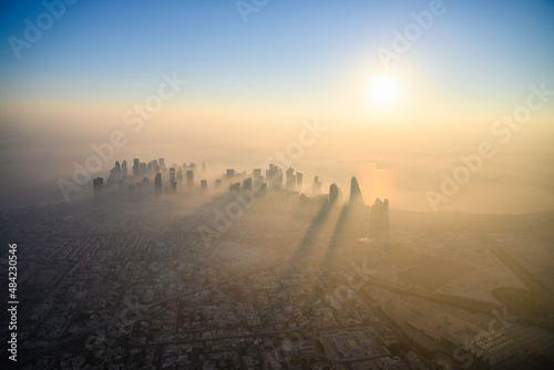 Doha skyline at sunrise with morning fog photo