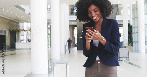 Make winning a habit. 4k video footage of a young businesswoman receiving good news on her smartphone.