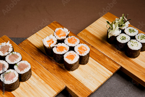 Japanese food: maki and nigiri sushi set on wooden background. Flat lay top-down composition. Copyspace photo