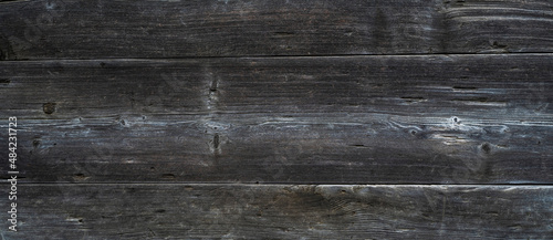 Old dark color wood wall for seamless wood background and texture. Rustic weathered barn wood background with knots and nails.