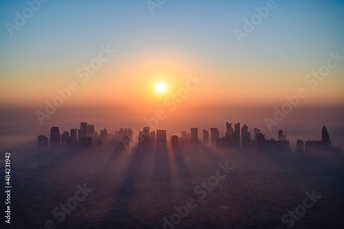 Doha skyline at sunrise with morning fog photo