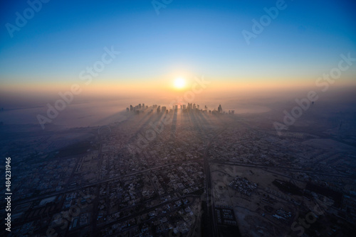 Doha skyline at sunrise with morning fog photo