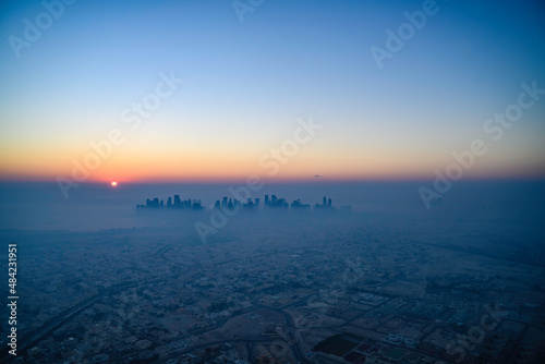 Doha skyline at sunrise with morning fog