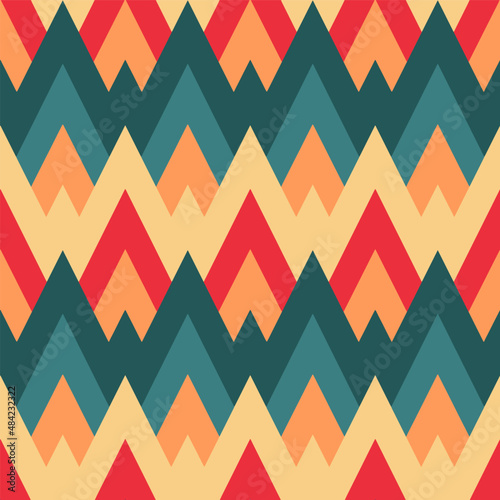 Colorful spiky waves. Overlapping zig zag wavy in retro colors. Seamless repeat pattern. Background texture for posters, cards, scrapbooking, fabric, wrapping paper or banners.