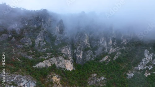 Erosion landscape with fog and griffon vultures flying overhead in the Valdivielso Valley. The Meringues. Burgos, Castilla y Leon, Spain, Europe photo