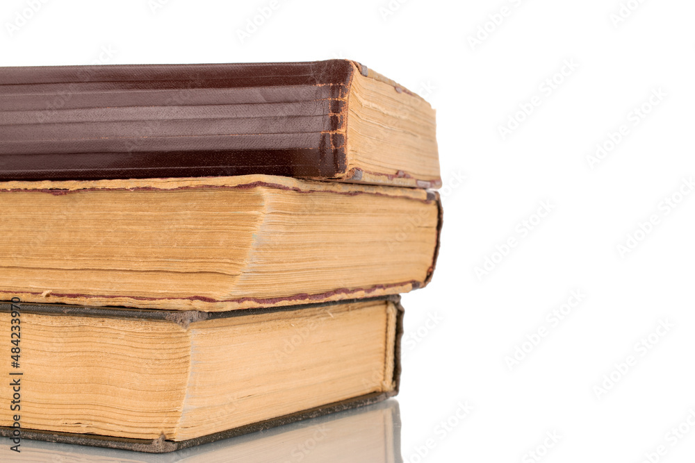 Three old books, macro shot, isolated on a white background. Three old books, macro shot, isolated on a white background.