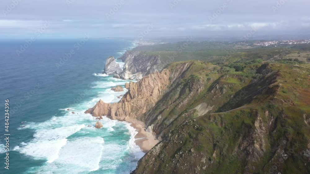 aerial view of the westernmost point of Europe Cape Roca and the red lighthouse on the rocks in Portugal aerial view of the westernmost point of Europe Cape Roca and the red lighthouse on the rocks in Portugal