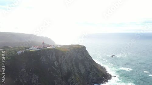 aerial view of the westernmost point of Europe Cape Roca and the red lighthouse on the rocks in Portugal