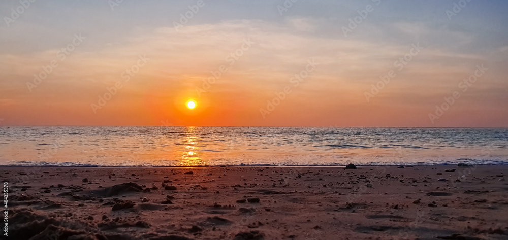 Sunset Beach with palm trees and beautiful sky landscape. Travel, Tourism, vacation concept background. Mexico. Paradise scene of Caribbean Island. Beautiful coconut palms silhouettes over orange sun Sunset Beach with palm trees and beautiful sky landscape. Travel, Tourism, vacation concept background. Mexico. Paradise scene of Caribbean Island. Beautiful coconut palms silhouettes over orange sun