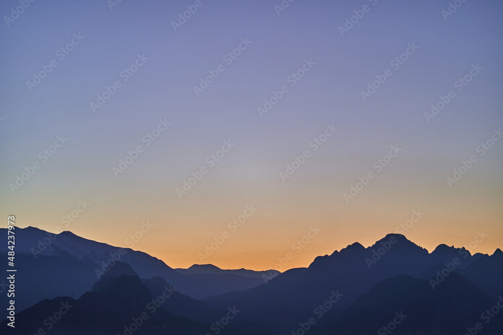 Silhouette of mysterious misty mountains at sunset