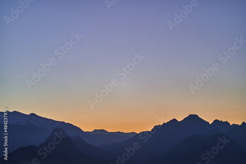 Silhouette of mysterious misty mountains at sunset