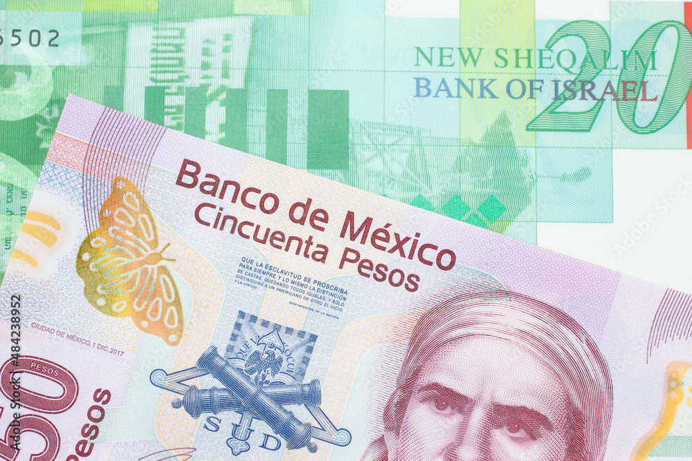 Fototapeta premium A macro image of a pink, plastic fifty peso bank note from Mexico paired up with a green and white twenty shekel bill from Israel. Shot close up in macro.