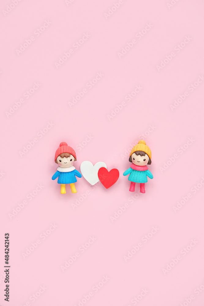 Fototapeta premium two toy dolls with red and white hearts on pink background. cute toy friends with hearts. 14 february, Valentine's day, Love, romance, friendship concept. flat lay. copy space