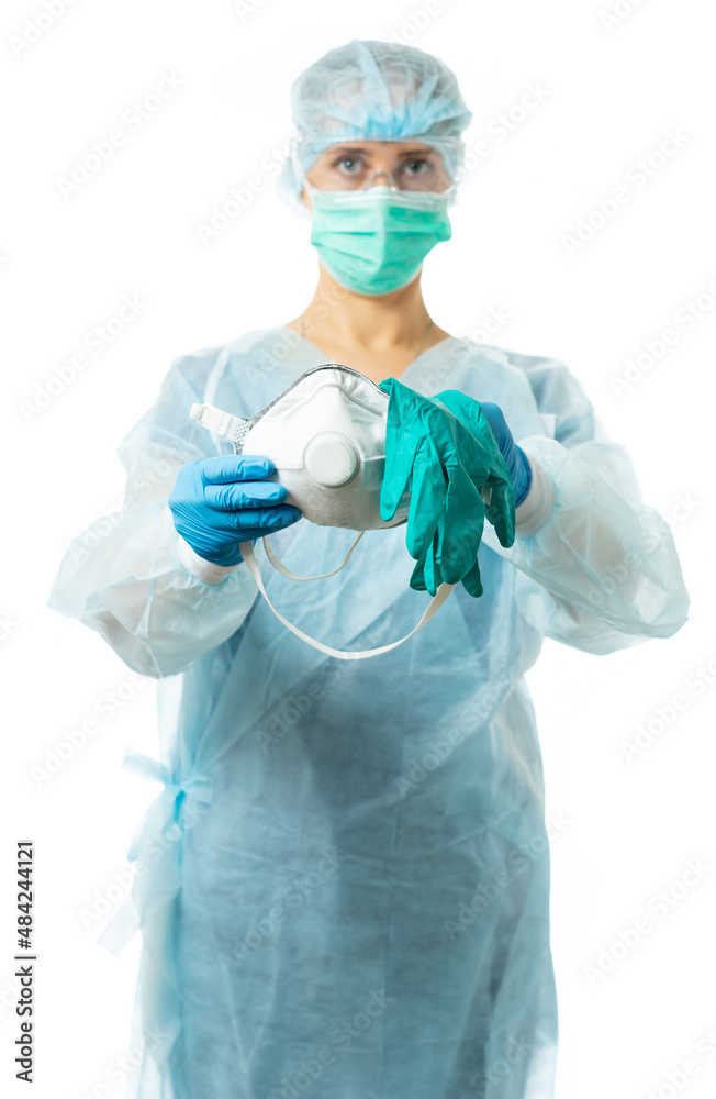 Laboratory assistant, a doctor in protective medical clothing looks at us and holds out a respirator and gloves, personal protective equipment. protect yourself and your loved ones. isolated Laboratory assistant, a doctor in protective medical clothing looks at us and holds out a respirator and gloves, personal protective equipment. protect yourself and your loved ones. isolated