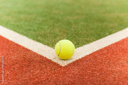 Tennis ball on an artificial map. Horizontal frame with copy-paste © yallowww