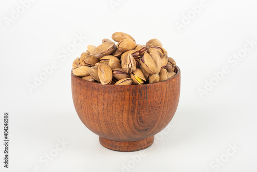 Pistachio in a bowl on white background