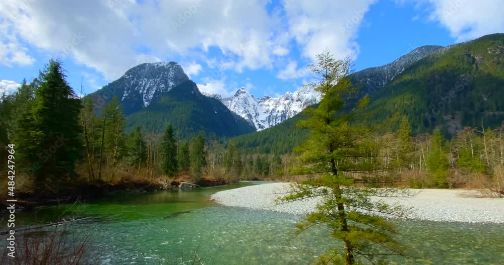 Establishing shot of majestic mountain creek with rocky background in Vancouver, Canada, North America. Day time on September 2021. Still camera view. ProRes 422 HQ. Establishing shot of majestic mountain creek with rocky background in Vancouver, Canada, North America. Day time on September 2021. Still camera view. ProRes 422 HQ.