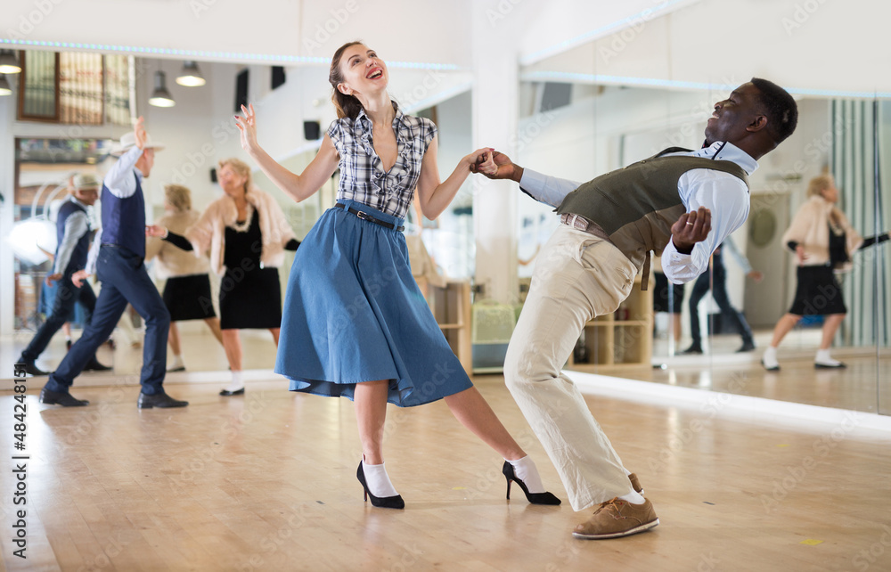 Obraz premium Woman with african man practising charleston dancing