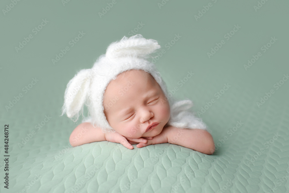 Sleeping newborn baby on a green background. Photoshoot for the newborn. A few days from birth. Sleeping newborn baby on a green background. Photoshoot for the newborn. A few days from birth.