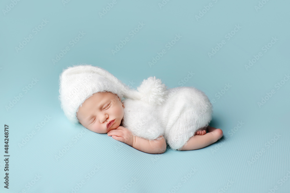 Sleeping newborn baby on a blue background. Photoshoot for the newborn. A few days from birth. Sleeping newborn baby on a blue background. Photoshoot for the newborn. A few days from birth.