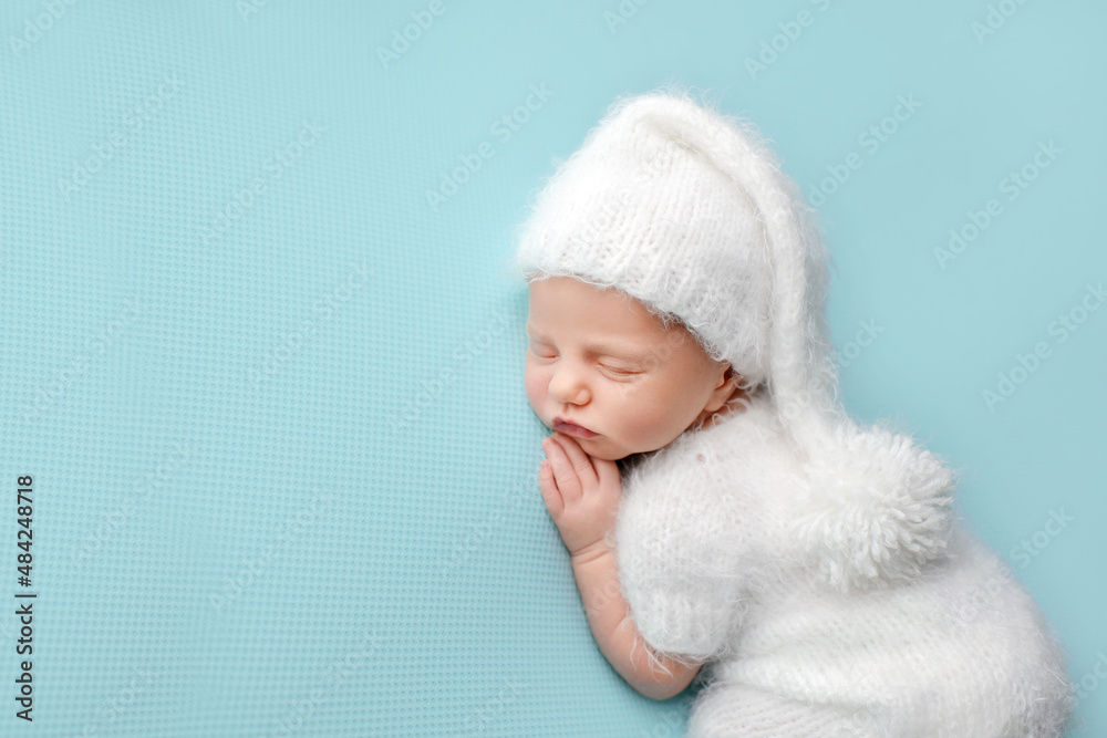 Sleeping newborn baby on a blue background. Photoshoot for the newborn. A few days from birth. Sleeping newborn baby on a blue background. Photoshoot for the newborn. A few days from birth.