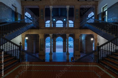 The typical columns and staircases of the famous Spanish square in Seville during a foggy morning with a view on the side towers of the monument built in 1928 for an exhibition. 