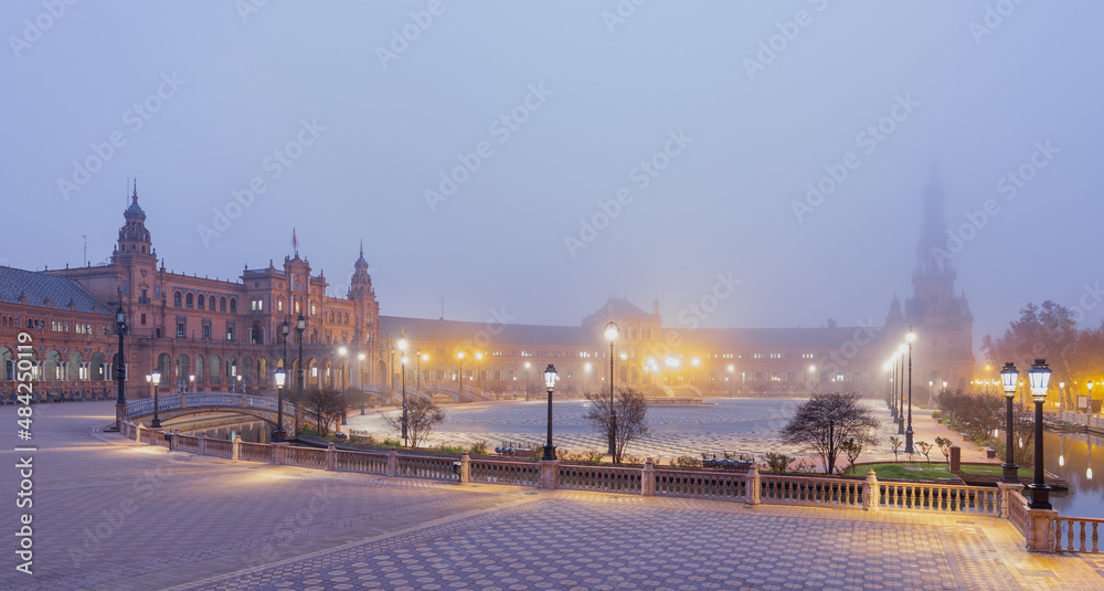 The famous Spanish square in Seville during a sunrise covered in fog. It is built in 1928 for the Ibero-American Exposition. It is a landmark with regionalism architecture and mixing elements. 
