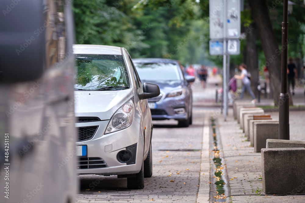 City traffic with cars parked in line on street side City traffic with cars parked in line on street side