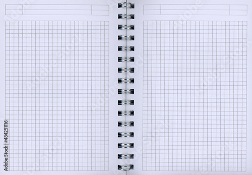 An open spiral block with white checkered paper