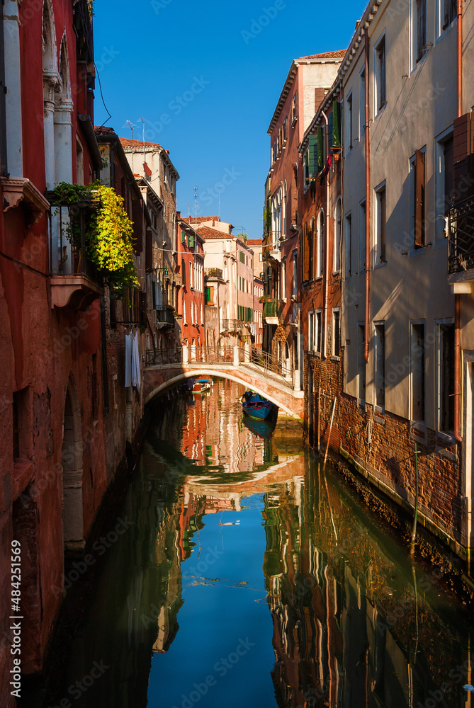 View of characteristic Venice canal with old traditional and colorful houses