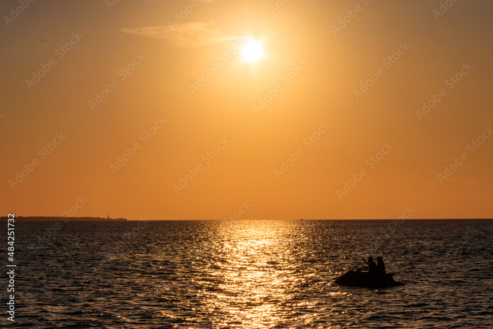 Silhouette of personal watercraft in the Indian ocean at sunset in Zanzibar, Tanzania