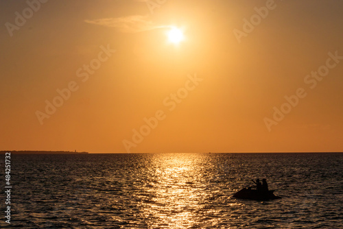 Silhouette of personal watercraft in the Indian ocean at sunset in Zanzibar, Tanzania © olyasolodenko